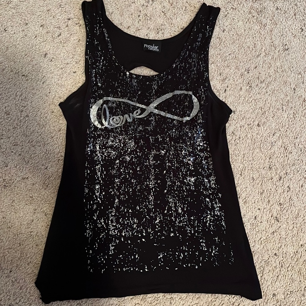 Black tank top with silver splashes and lettering on it